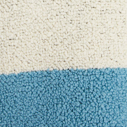 Close-up of the knit texture on a custom alpaca sweater in blue and white.