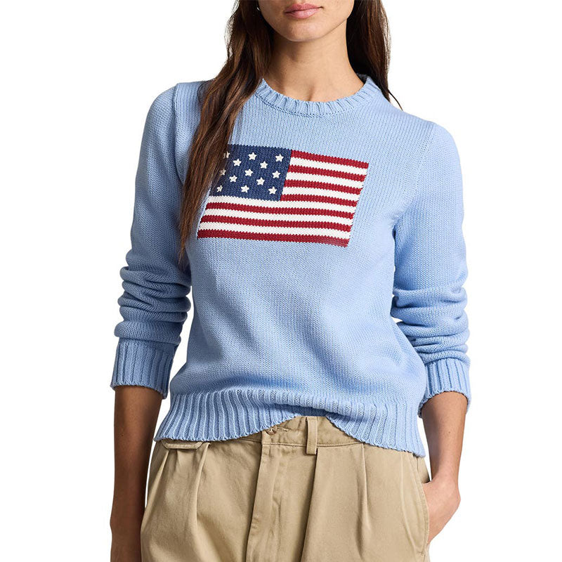 Back view of a light blue knit sweater showing the ribbed cuffs and hem. The sweater has a simple, clean design with a crewneck and long sleeves.