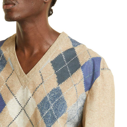 Close-up of a beige and blue argyle sweater in a cashmere blend, showing the V-neck and pattern detail.