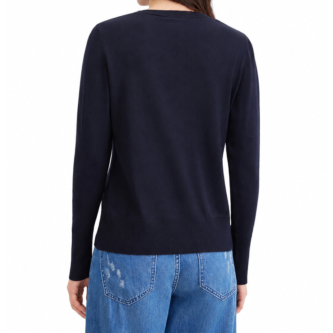 Back view of a woman wearing a black knit cardigan.