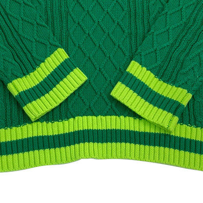 Close-up of green knit sweater cuffs and hem with contrasting ribbed stripes – premium finish for custom letter sweaters.