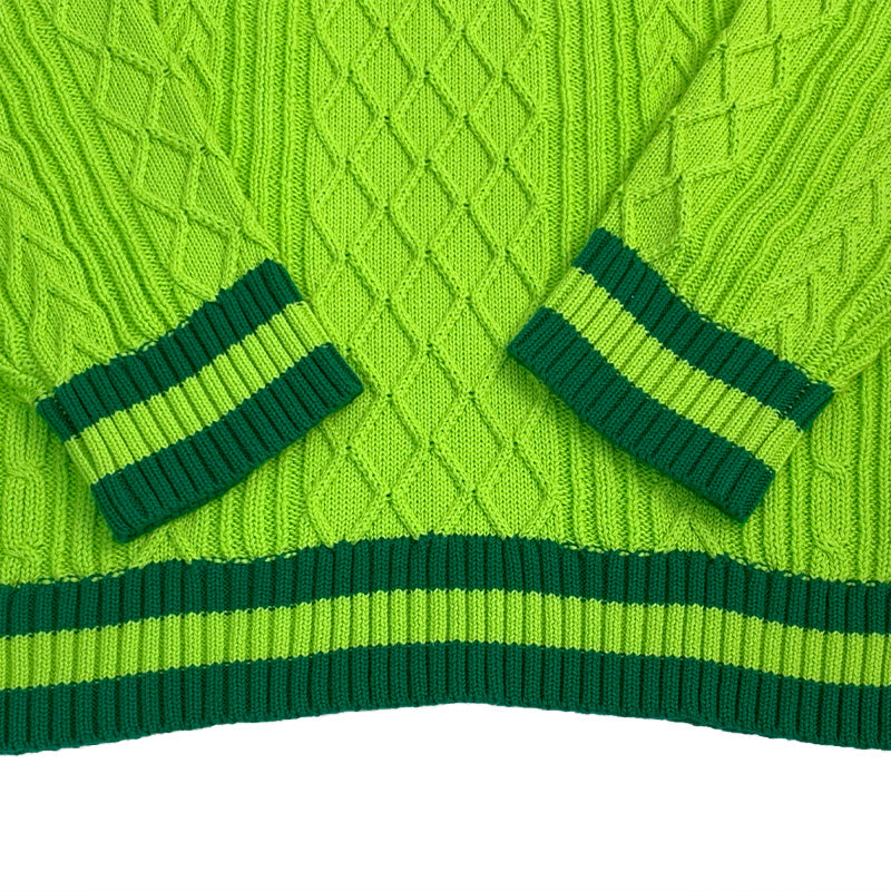 Bright green cable knit sweater cuffs and waistband with deep green stripe accents – showcasing quality craftsmanship.