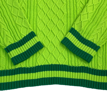 Bright green cable knit sweater cuffs and waistband with deep green stripe accents – showcasing quality craftsmanship.