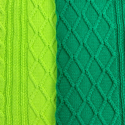 Side-by-side fabric comparison of light and dark green diamond knit patterns – customizable options from a sweater manufacturer.