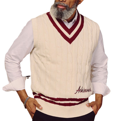 Man wearing cream cable knit vest with maroon trim and "Achievemen" embroidery