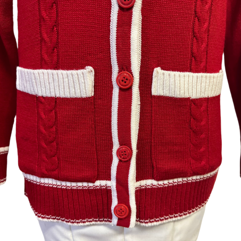 Close-up of red cardigan with white trim and buttons