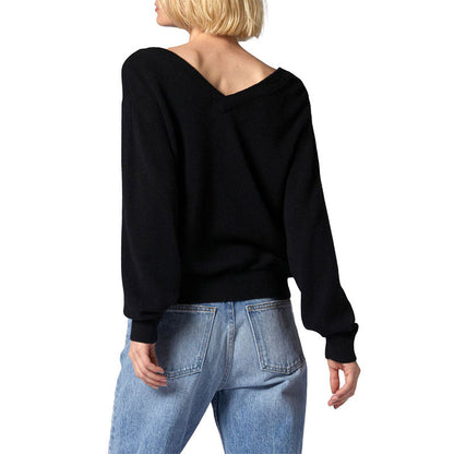 Back view of a black V-neck wool blend pullover sweater with a relaxed fit, highlighting the simple design and ribbed hem.