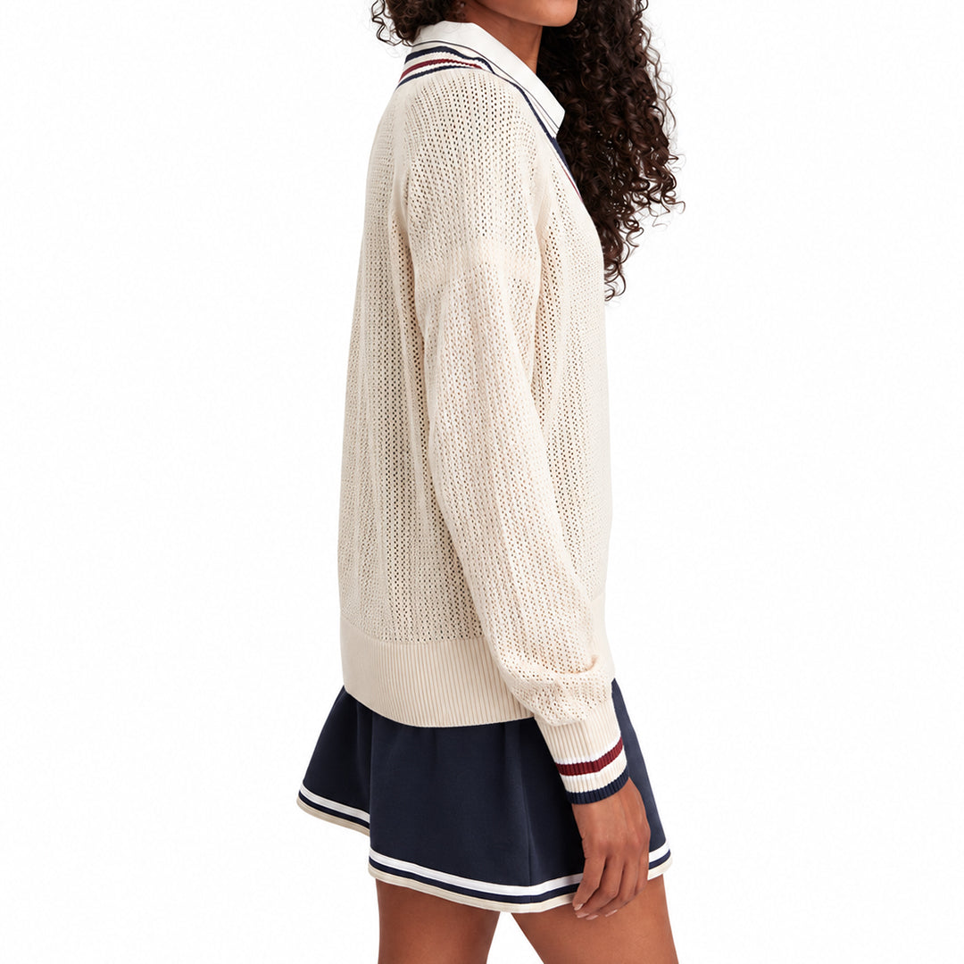 Side view of a cream long-sleeve varsity knit sweater