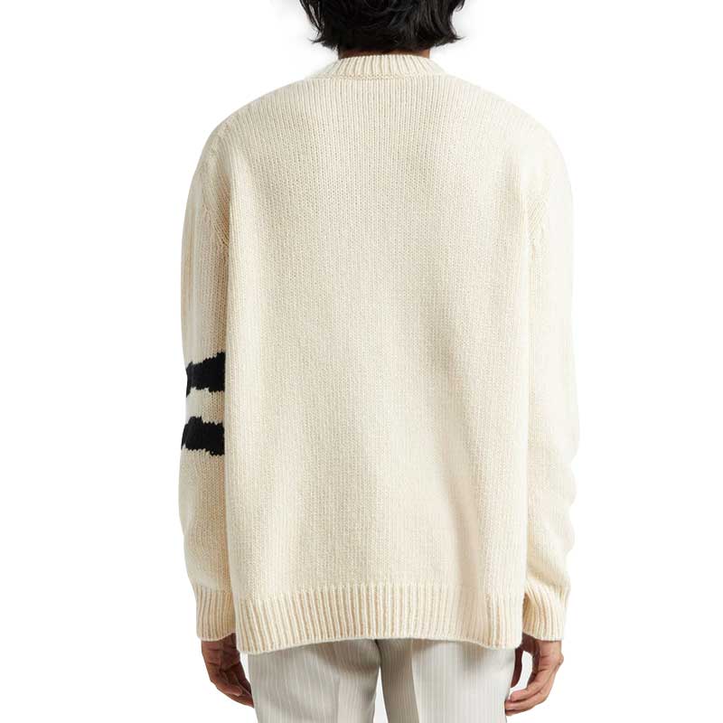 Back view of a custom wool blend knit sweater in off-white, showcasing the clean design with ribbed cuffs and hem, and a subtle stripe on the sleeve.