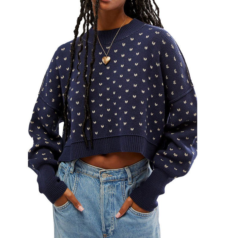 Front view of a custom navy blue cropped knit sweater with a small butterfly pattern, showcasing a casual fit paired with high-waisted jeans.