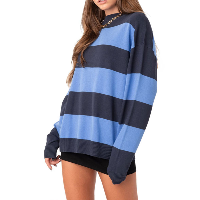 Side view of a woman in a blue and navy striped cotton pullover sweater.