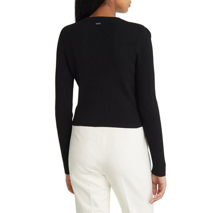 Back view of a black ribbed knit cardigan, worn by a model.