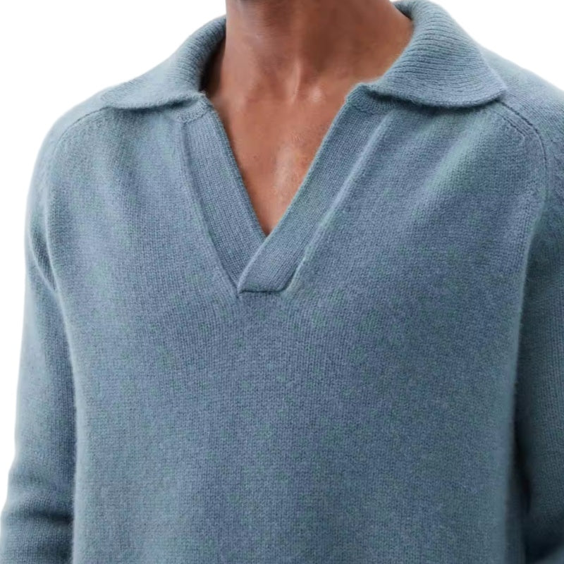 Close-up of the front design and collar of a blue 100% cotton premium quality men’s knit pullover sweater