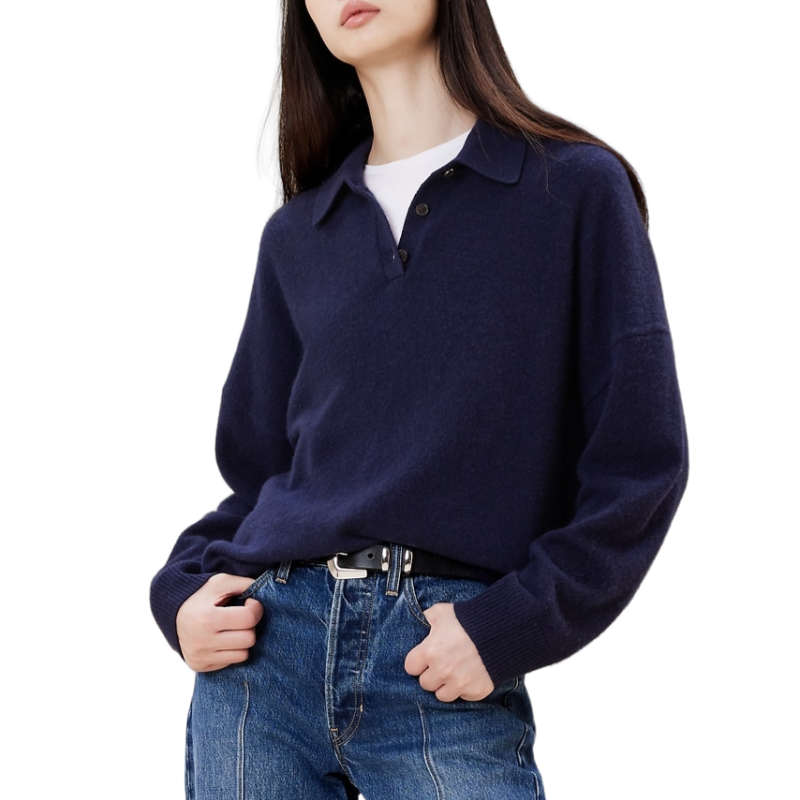 Woman wearing a navy blue cashmere blend knit sweater with a polo collar, paired with denim jeans