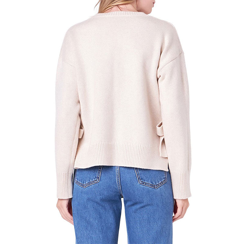 Back view of a custom oversized cotton blend knit sweater in beige, showcasing the simple design and ribbed hem.