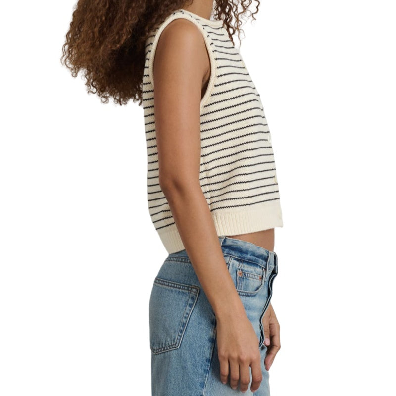 Side view of a woman wearing a custom stripe knit vest in a cream and black cotton blend, paired with high-waisted jeans.