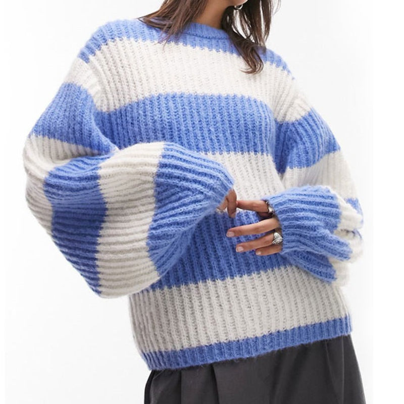 Close-up view of a woman wearing a custom wool blend ribbed knit sweater with blue and white horizontal stripes, highlighting the oversized sleeves.