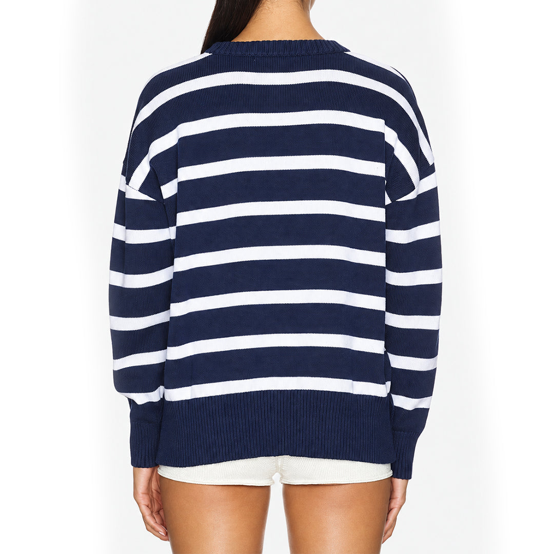 Back view of a navy and white striped women's knit sweater