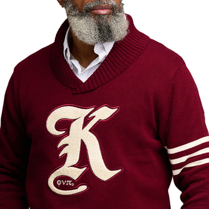 Close-up of an older gentleman wearing a maroon custom fraternity sweater with white stripes on the sleeves and the text 'K' on the front.