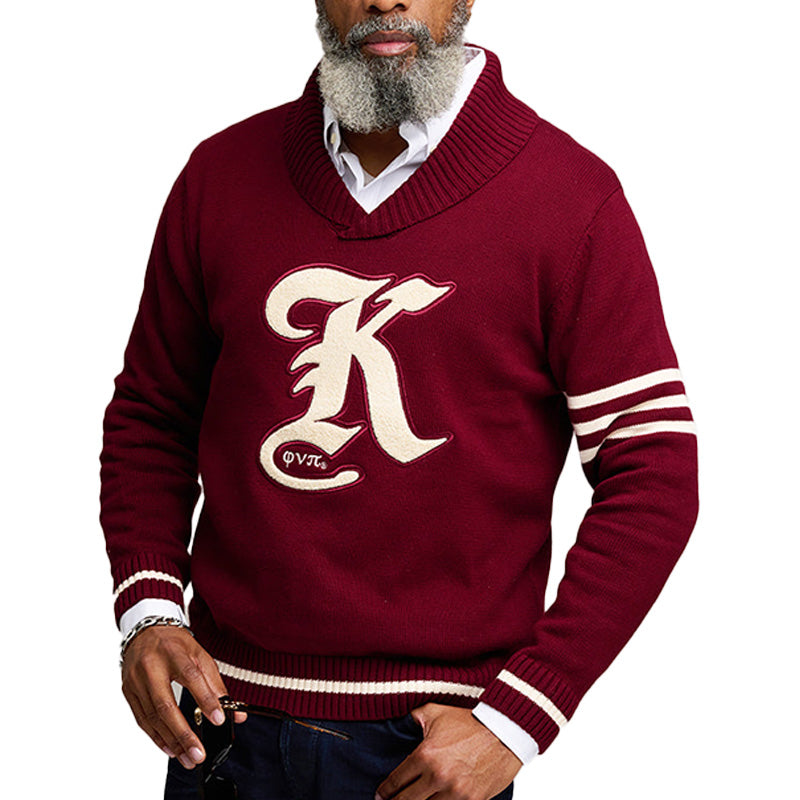 An older gentleman wearing a maroon custom fraternity sweater with white stripes on the sleeves and the text 'K' on the front, holding a pair of sunglasses.