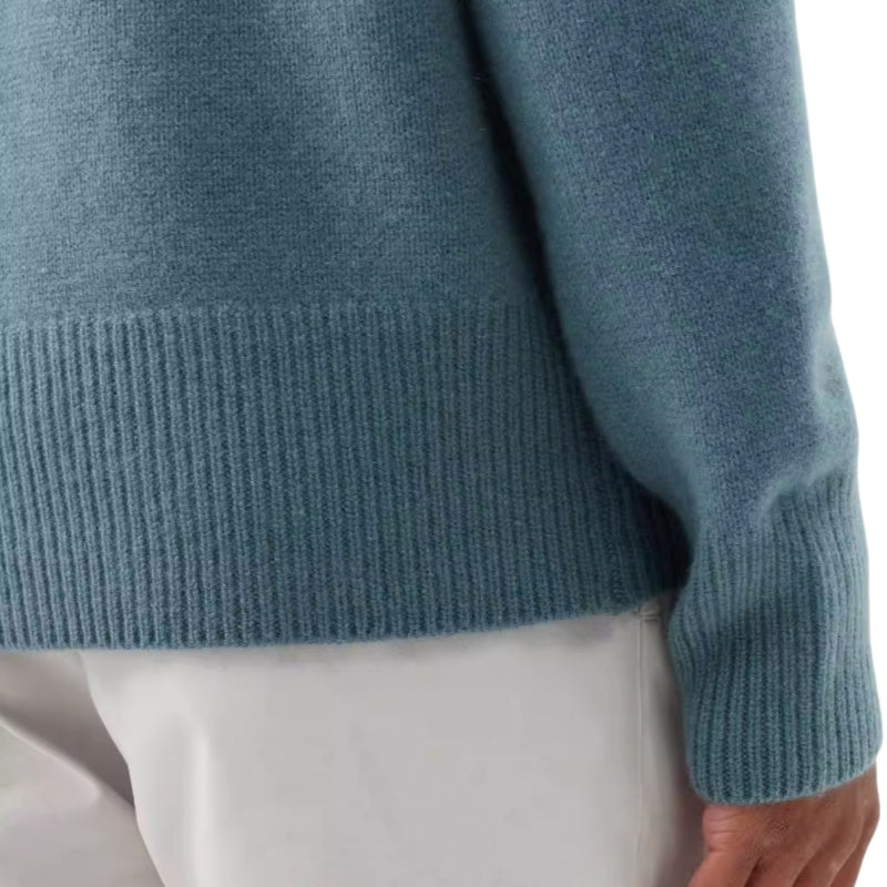 Close-up of the ribbed hem of a blue 100% cotton premium quality men’s knit pullover sweater