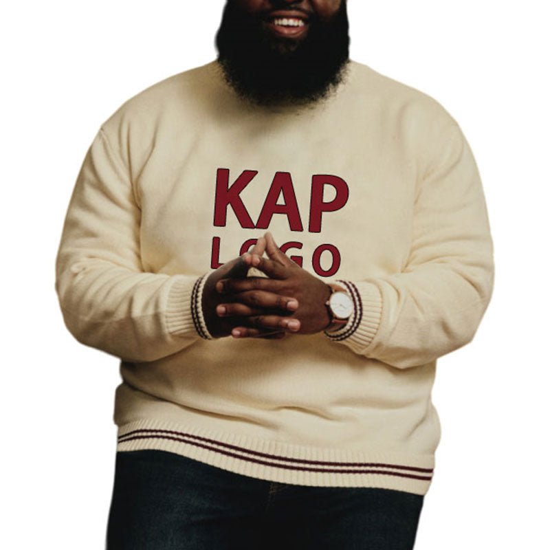 Smiling man wearing a custom fraternity sweater in cream with maroon text 'KAP LOGO'.