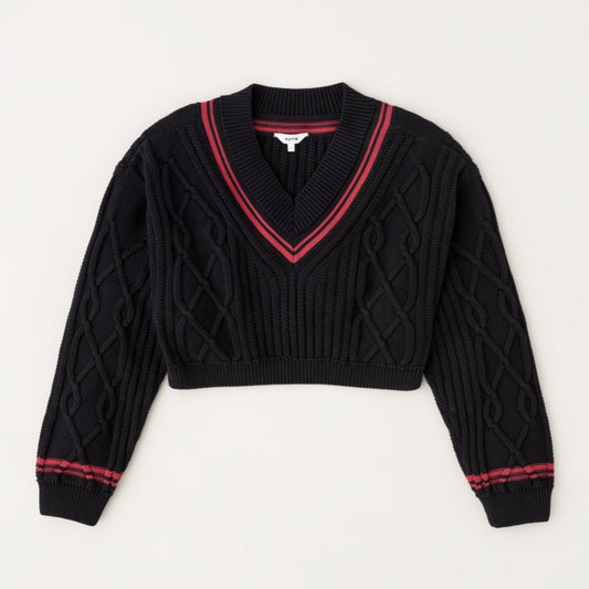 Flat lay of a black V-neck knitted sweater with red accents and intricate cable knit patterns.
