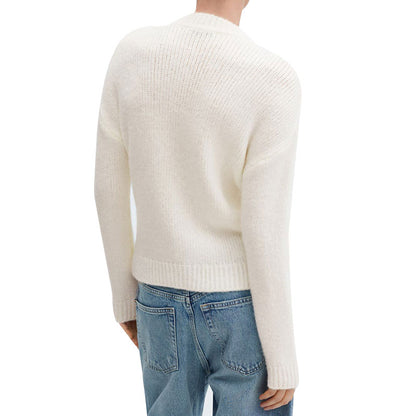 Back view of a cream-colored sweater worn by a model with blue jeans. The sweater has a simple textured knit design with ribbed cuffs and hem.