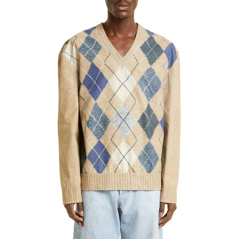 Front view of a model wearing a beige and blue argyle sweater in a cashmere blend.