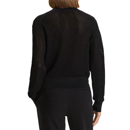 Back view of a black hollow out knit sweater, displaying the see-through design, long sleeves, and ribbed cuffs and hem.