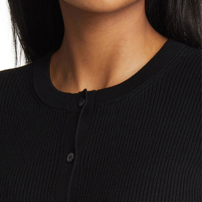 Close-up of the crew neck and buttons on a black knit cardigan.