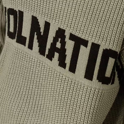 Close-up of a green ribbed knit sweater showing a custom logo text in black across the chest.