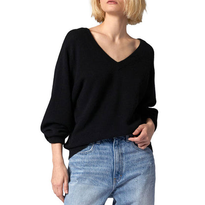 Front view of a black V-neck wool blend pullover sweater with a classic fit, paired with light-wash jeans for a casual look.