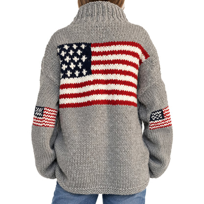 Side view of grey American flag knit sweater with ribbed cuffs