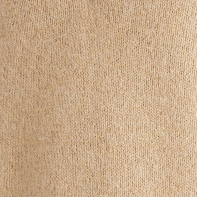 Close-up view of beige wool blend knit fabric, highlighting texture and material quality.