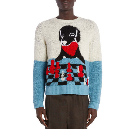 Front view of a model wearing a custom alpaca sweater featuring a cartoon dog design with a red heart and chessboard, in blue and white knit.