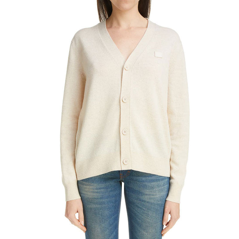 Model wearing beige V-neck cardigan sweater - tailored knitwear for women.