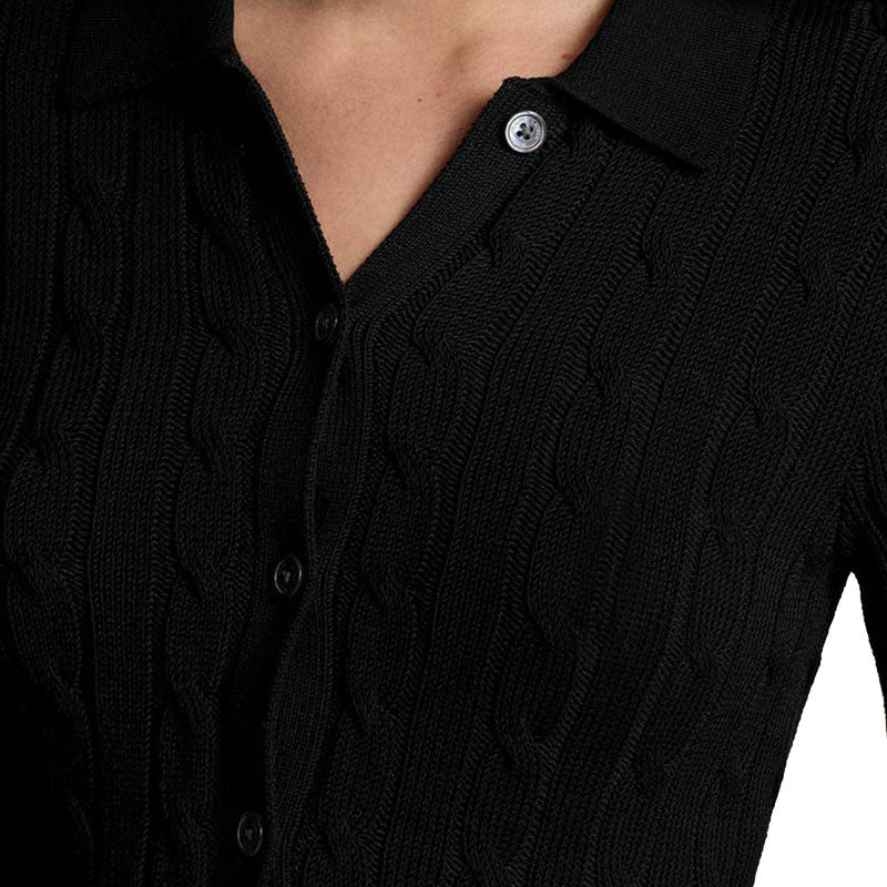 Close-up of the black short-sleeve cable knit polo sweater's button details and collar.