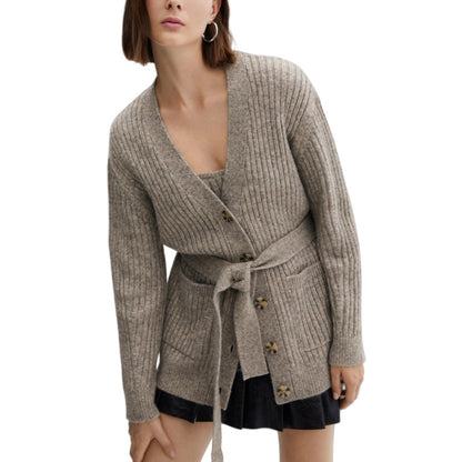 Fashion model showcasing a grey cotton knit cardigan with a belt, highlighting the fitted style and ribbed knit pattern.