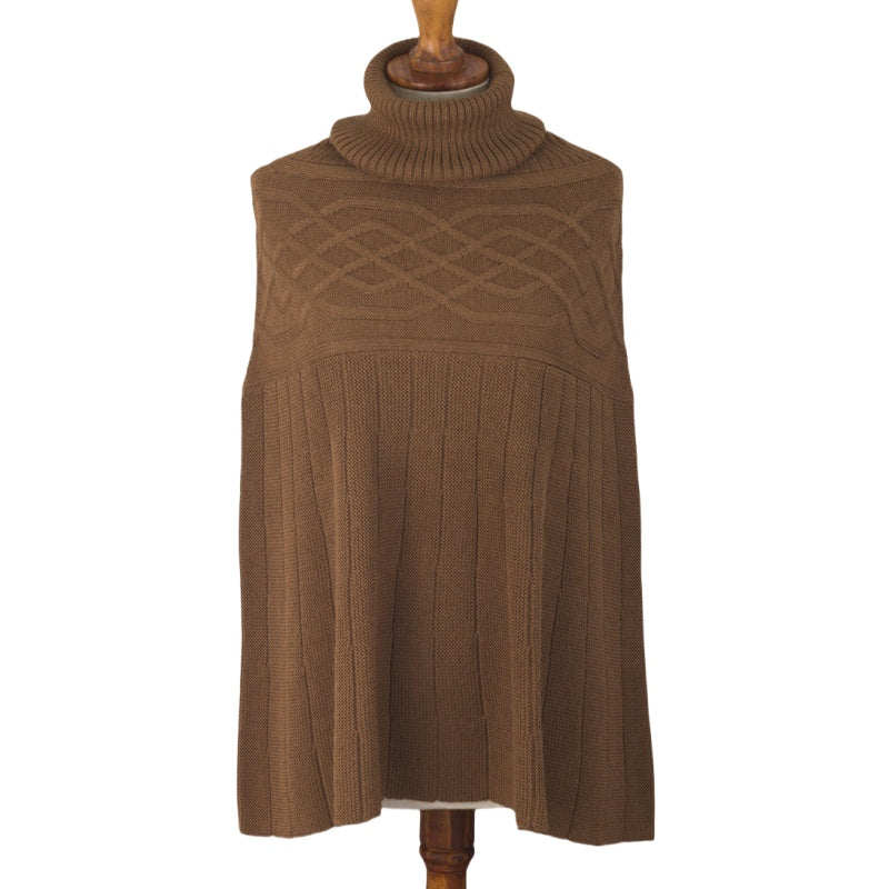 Brown 100% cotton knit poncho displayed on a mannequin, featuring a cozy turtleneck and detailed with an intricate cable knit pattern on the upper part and vertical ribbing on the lower half.