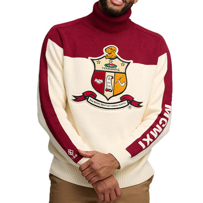 Man posing in a custom fraternity sweater featuring a red top and cream bottom, with 'Kappa Alpha Psi' logo embroidered displayed on the front and 'MCIMXI' on the sleeve.