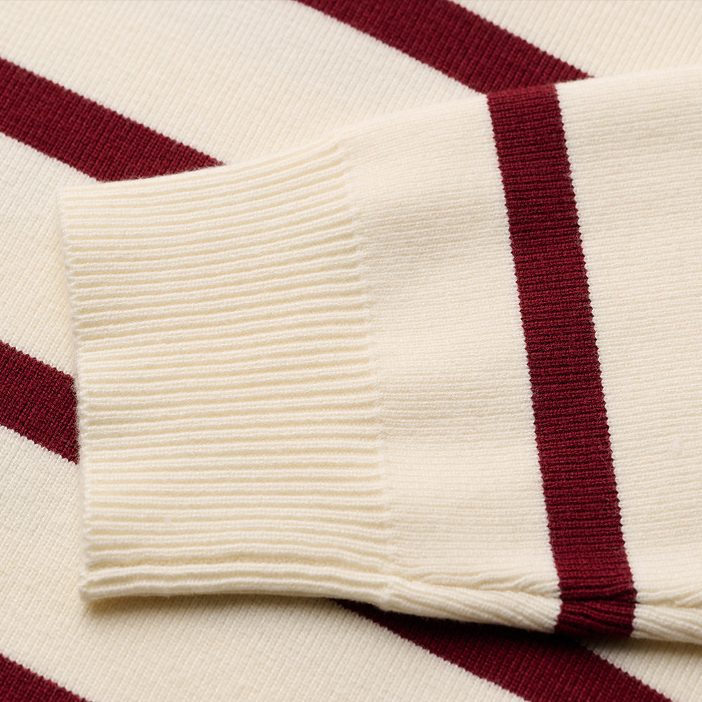 Close-up of the cuff on a maroon and white striped custom Greek knit sweater, highlighting the ribbed texture.