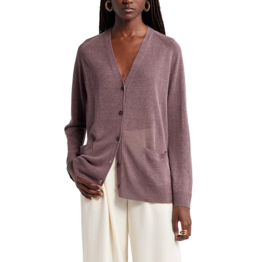 Front view of a woman wearing a custom button knit cardigan in a linen blend. The cardigan is in a mauve color, featuring a V-neckline and two front pockets. She pairs it with white pants and hoop earrings.