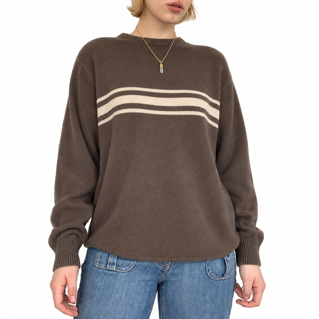 Close-up of the cream horizontal stripes on a brown knit pullover.