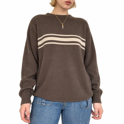 Close-up of the cream horizontal stripes on a brown knit pullover.