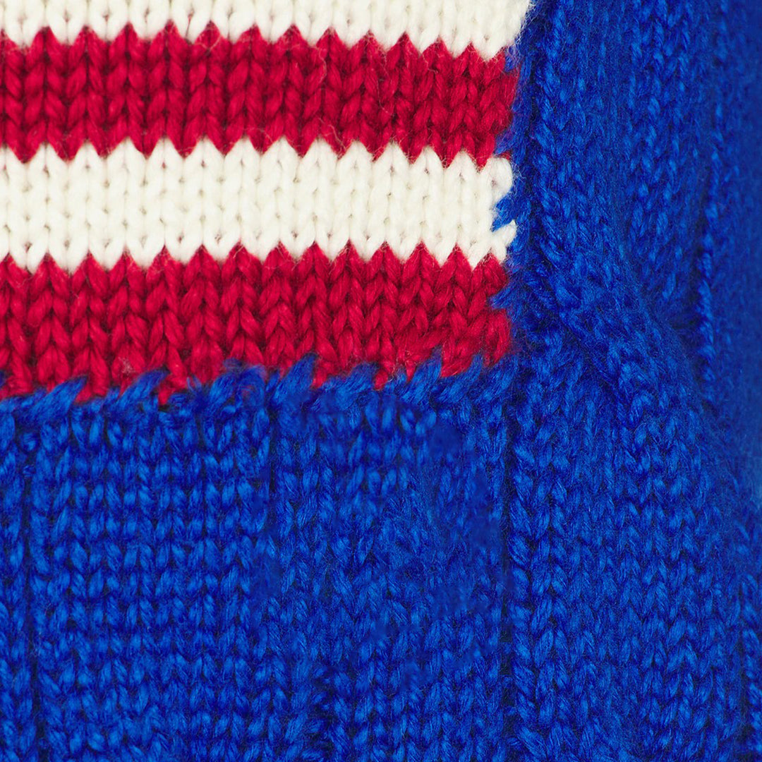 Close-up of red white and blue American flag motif on blue knit fabric