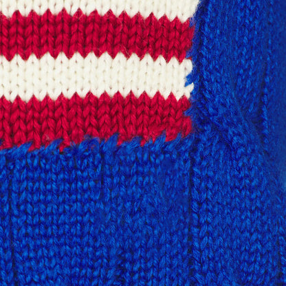 Close-up of red white and blue American flag motif on blue knit fabric