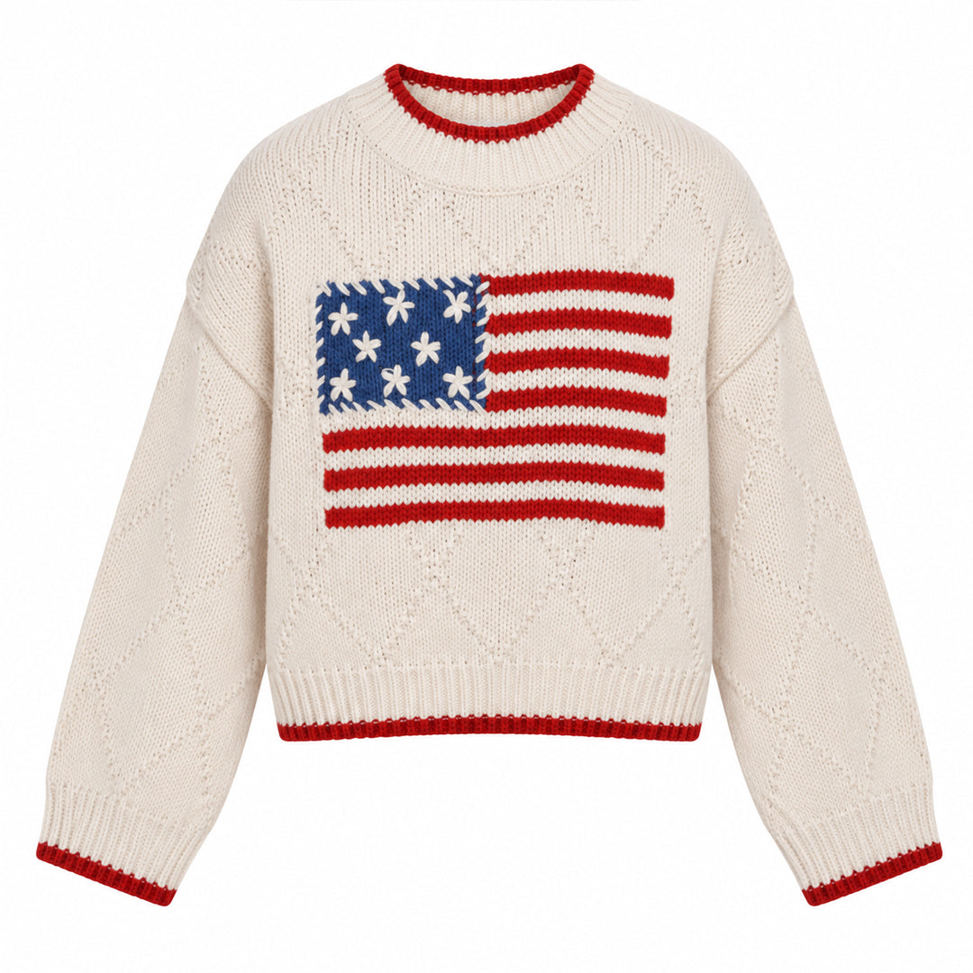 Flat lay of cream American flag knit pullover with red ribbed trims