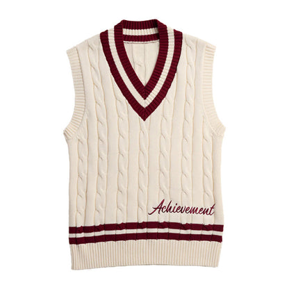 Cream cable knit vest with maroon trim and "Achievement" embroidery
