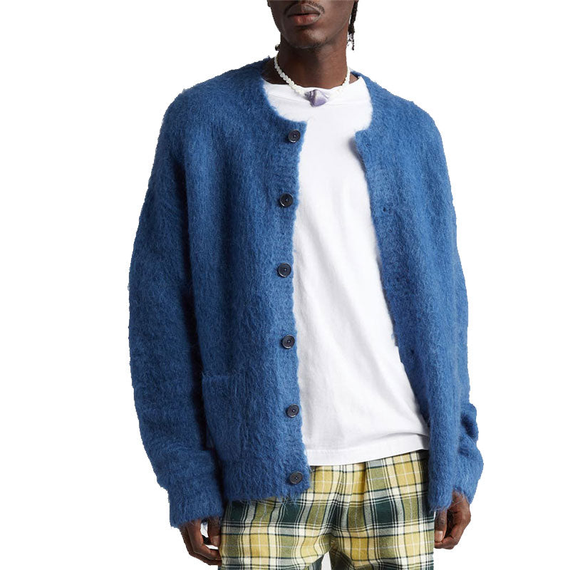 Man wearing a blue custom wholesale wool blend solid crew neck cardigan sweater over a white T-shirt